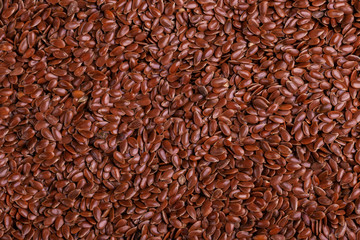 Obraz premium Brown flax seeds background. Close up. Top view
