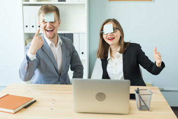 Business, break and people concept - Cheerful man and woman playing games in office while working