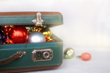 festive retro set Glass New Year  toys visible in the half-open front view of a suitcase
