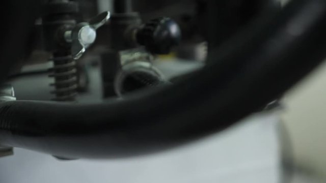Move the paper sheets in the printing press suction cups. Professional printing machine in the typography. Close up.