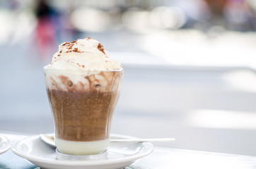 Photograph of a hot chocolate and coffee with cream.
