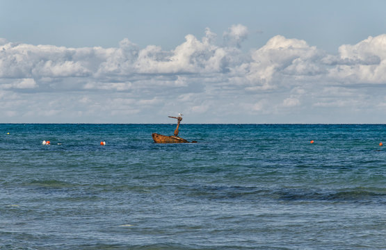 Rusty sunken boat near the beach