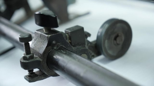 Roller rotation of professional printing machine in the printing house. Offset printing machine in typography.
