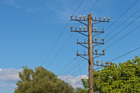 old wooden telegraphic pillar and blue sky