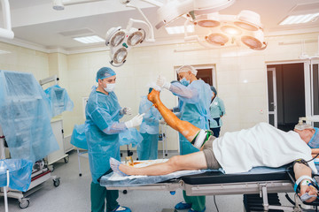 doctor and an assistant in the operating room for surgical venous vascular surgery clinic