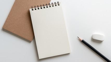 open blank spiral notebook with pencil and eraser on white background.Empty Space for your text. - obrazy, fototapety, plakaty
