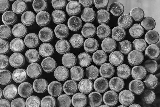 Close up of rows of Steel Round Bar for industrial construction. Black and white with Shallow focus.
