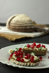 sandwich with cheese, greens and pomegranate berries