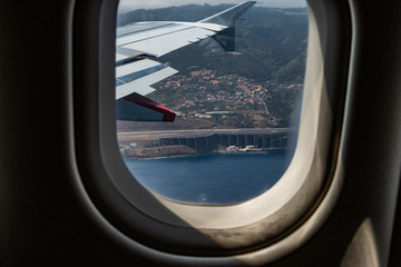 Fototapeta premium The runway Funchal through the window of the aircraft.