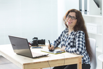 Illustrator, web designer and artist concept - Graphic designer using her pen tablet in a bright office