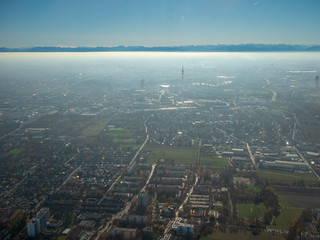 Helicopter view to Munich Region with autumn fog and long view to alps 