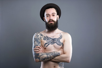 Man in Hat. Hipster boy with tattoed body
