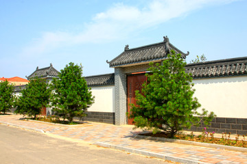 Fototapeta na wymiar traditional Chinese architectural style gate house and walls, China