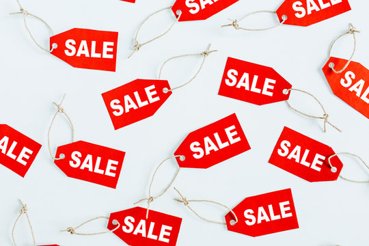 Black Friday sales discount composition. Red tags with word SALE on white background. Flat lay, top view.