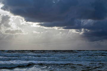 Beautiful evening clouds over the storming Bali Sea