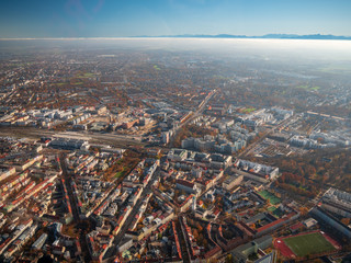 Obraz premium Helicopter view to Munich Region with autumn fog and long view to alps 
