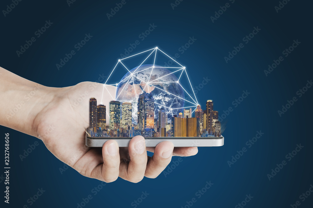 Poster hand holding mobile smart phone with modern buildings global network connection technology hologram.