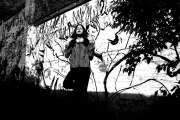 teen girl at graffiti wall 