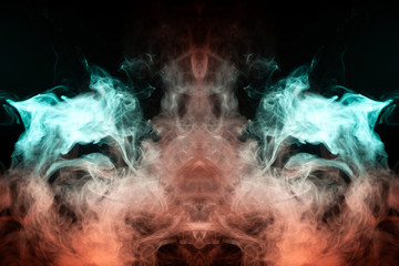 Abstract image of smoke of different colors in the form of horror in the form of the head of the face and eyes on a black isolated background. Soul and ghost in mystical form.