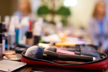 Obraz na płótnie Canvas Brush for blush close-up on the table of a makeup artist with cosmetics.