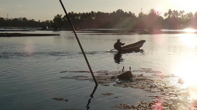 boy earns living as fisherman in a lake using boat