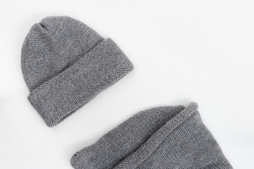 Woolen knitted clothing, wool cap, and scarf. Warm winter clothes. Top view. Copy space. Flat lay.