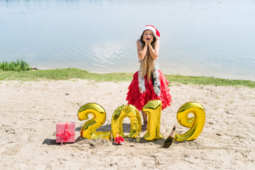 Woman in red dress posing with new year decorations