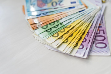 Colorful euro banknotes in fan on wooden table