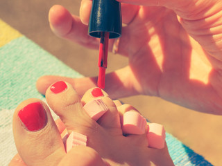 Woman pedicure with red nail polish