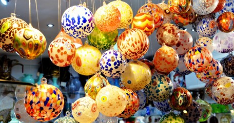 multicolored venetian balloons made of glass decorating a vitrine