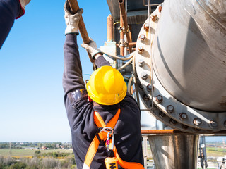 worker at work at height with personal protective equipment