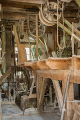 Traditional artisan wooden flour mill equipment, viewed from side and other mill pully equipment, beamed celings very visible