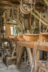 Traditional artisan wooden flour mill equipment, viewed from side and other mill pully equipment.