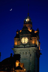Fototapeta na wymiar Balmoral Clock Tower at night with crescent moon , Edinburgh, Scotland