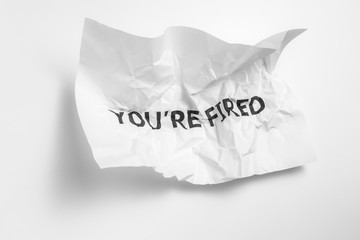 The inscription on the crumpled paper "You are fired" as a notification from the place of work