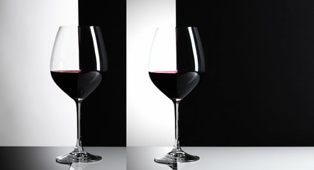 Glasses of red wine on a reflexive background.