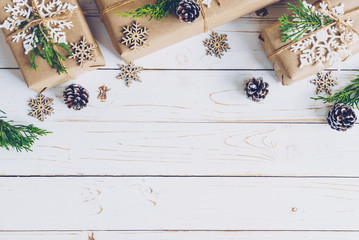 Homemade wrapped christmas gift box presents on a wood table background.