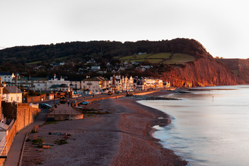 Warm early morning light on Sidmouth seafront and cliffs of Jurassic Coast, Devon,