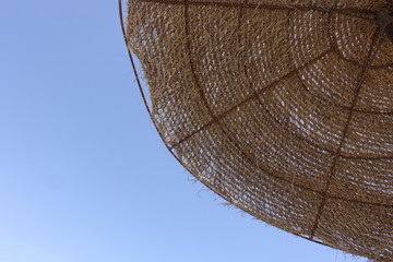 Summer background - parasol and blue sky. 