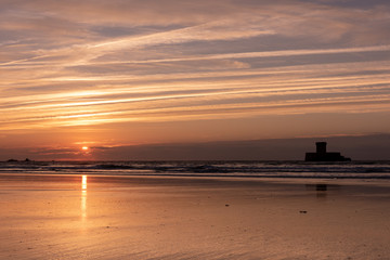 Gorgeous reflections at sunset on St Ouens Bay beach, Jersey, Channel Islands