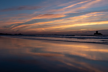 Gorgeous reflections at sunset on St Ouens Bay beach, Jersey, Channel Islands