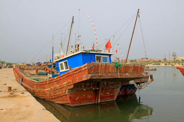 Fototapeta na wymiar Fishing boats waiting in port wharf