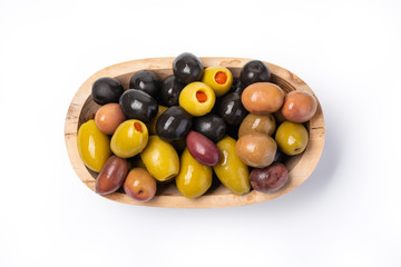  olives in a wooden bowl isolated against a white