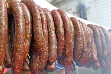 Grilling sausages, burgers, pork steak on barbecues gas grill for party. Hot dogs,sausages and hamburgers on a barbeque, bbq. Smokes meat food outdoors, fast food. Hamburgers. Pleskavitsa