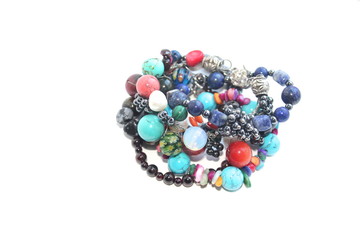 Handmade bracelets made of semi-precious and semi-precious stones on a white background. handwork. Fascinating hobby.