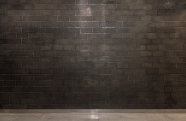 Spot lit empty room with grey brick wall and copy space