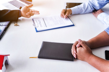 Business man is signing a contract for selling a new home. Concept home purchase contract.