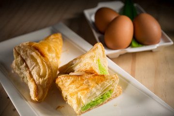 Pandanus or Kaya pie, homemade bakery pastry on wooden background, selective focus