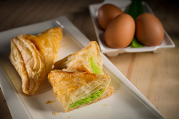 Pandanus or Kaya pie, homemade bakery on wooden background, selective focus