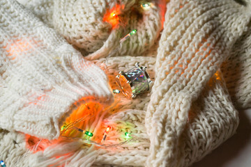 White knitted texture with decor. Soft clothes. Winter season.